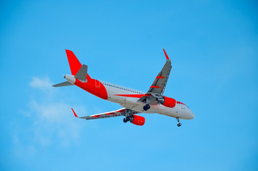 A beautiful corporate plane flies in the sky, a clear day in Portugal, tourist transport and mail delivery. bottom view.