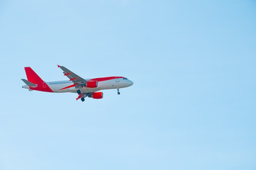 A beautiful corporate plane flies in the sky, a clear day in Portugal, tourist transport and mail delivery. bottom view.