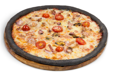 Black pizza with seafood on a wooden round plate on a white background. Cheese, shrimp, octopus, squid rings, tomatoes.