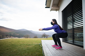 Woman doing exercise outdoors at home, Corona virus and quarantine concept.