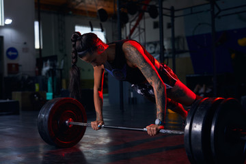 Woman doing push ups with weights.