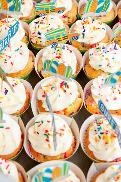 Rows of colorful cupcakes in a box.