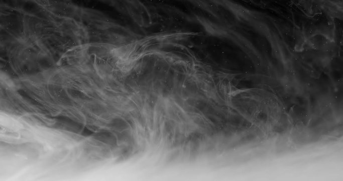 Close-up white ink spreads in water, smoke spreading underwater. Black and white abstract background. Can be graded in any color by tint effect