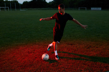 Footballer doing tricks on the pitch.