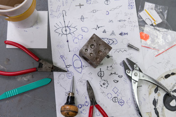 Jeweler tools and sketches on table