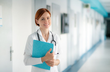 Portrait of woman doctor standing in hospital. Copy space.