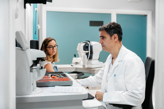 Oculist entering patient's data at the computer