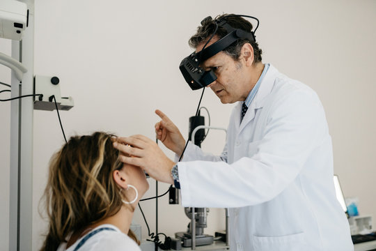 Ophthalmologist checking patient's eyes