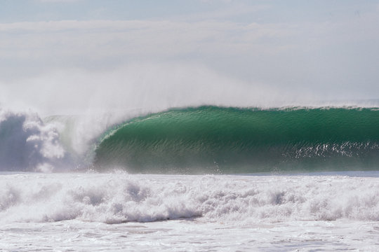 Giant barreling wave breaking on a sandbank