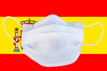 medical mask on the Spain flag. Quarantine, coronavirus pandemic, isolation.