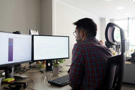 Young male developer working in the office
