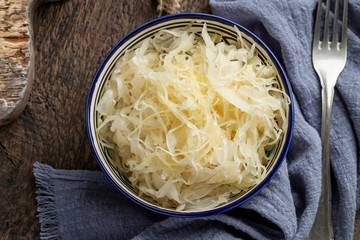 Fermented cabbage in a bowl, with a fork
