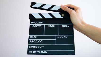 Obraz premium Hand holding film making clapperboard.