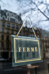 Sign at a shop window with the french text: "Ferme" that means "Closed"