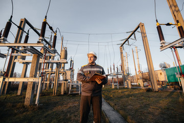 The energy engineer inspects the equipment of the substation. Power engineering. Industry
