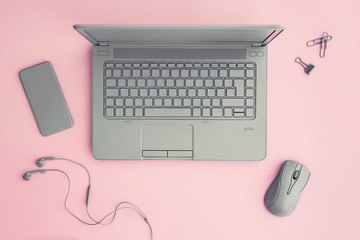 Office workspace on pink