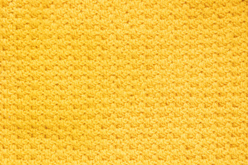 Yellow knitted fabric, close up
