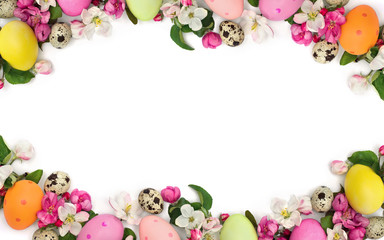 Naklejka na ściany i meble Easter decoration. Frame of pink flowers apple tree and colored easter eggs and quail eggs on white background with space for text. Top view, flat lay