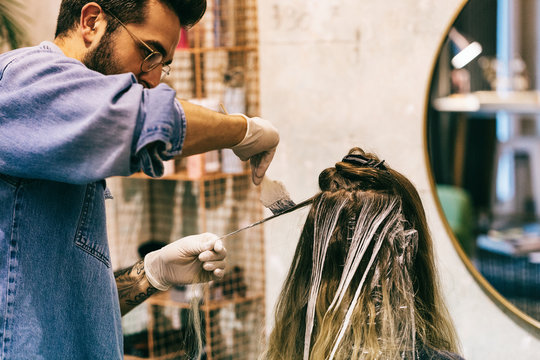 Closeup of Male Hairdresser Dyeing Hair