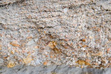 sedimentary layers of the rock in the sand scree. sand, pebbles and shells in sedimentary rocks.