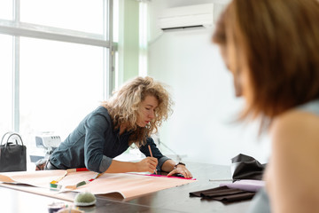 Women creating clothes in sewing studio