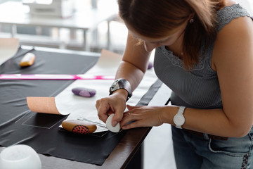 Woman outlining pattern on fabric
