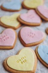 Obraz na płótnie Canvas Valentine's Day presents: Heart-shaped cookies with colorful glaze and themed lettering for all lovers