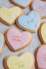 Valentine's Day presents: Heart-shaped cookies with colorful glaze and themed lettering for all lovers