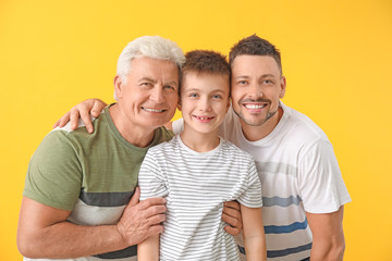 Man with his father and son on color background