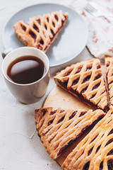 baked homemade cherry pie on the table with tea