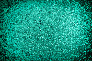 Bright photo of turquoise sparkles with vignette. Festive background for sites and layouts.