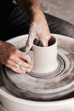 Potter throwing new shape on a wheel