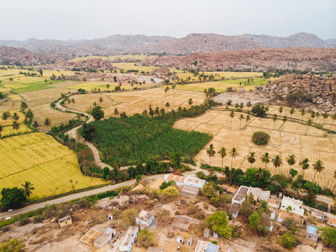 Aerial view of rural village close to rice fields