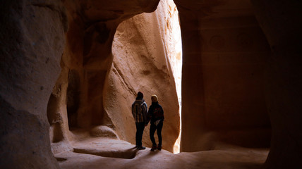 Travel couple standing into the cave surrounded by rock formations at Zelve Valley in Cappadocia, Turkey © Seckin Ozturk