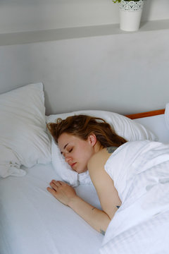 Young female sleeping at home