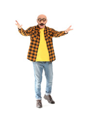 Portrait of emotional elderly man with party decor on white background