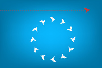 Think differently concept. Be different. Red bird changing direction. New idea, change, trend, courage, creative solution, innovation and unique way concept	