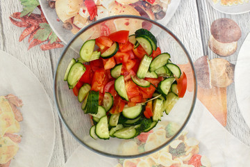 Sliced ​​cucumber and tomato vegetable salad in a glass bowl