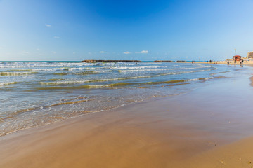 Surfers ride the waves on the Mediterranean coast