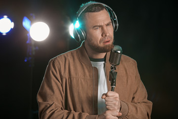 Male singer with microphone on stage