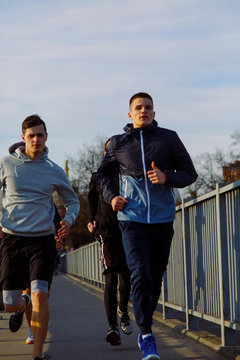 A bunch of guys running in the morning