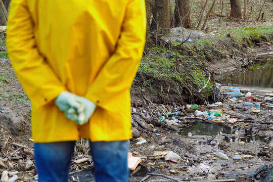 A man and a woman clean the reservoir of plastic and garbage.