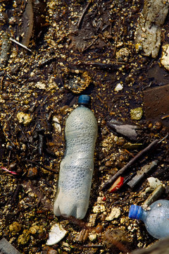 Plastic bottle and trash in the pond