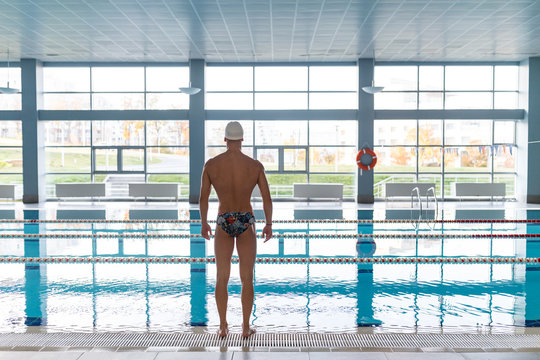 Athletic man in empty swimming pool