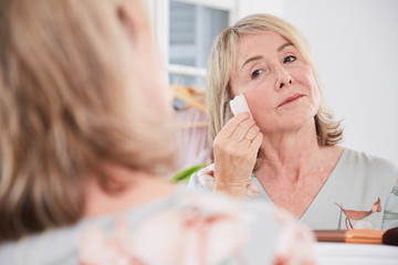 Mature woman using Gua Sha stone
