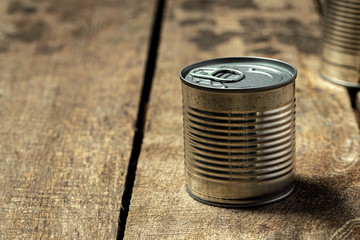 Tin cans with food on the table. Close up.