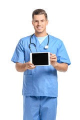 Portrait of young male doctor with tablet computer on white background