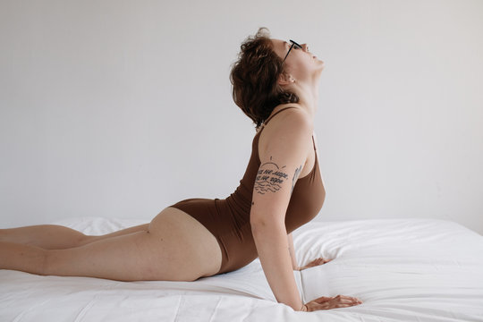 Woman stretching body on bed