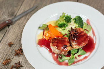 Paleodiet. Fried chicken fillet and broccoli with sauce. Food in a white plate blue background background.