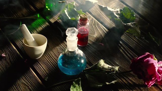 Witchcraft. Witch doctor desk table. Magic potion. ALternative medicine concept. Divination, love potion. Mysterious clouds of smoke.